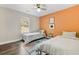 Bedroom featuring two twin beds, a window, and an orange accent wall with decor at 510 Mountainview Dr, Covington, GA 30016