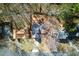 Overhead view of a home surrounded by lush trees and landscaping, showcasing the backyard deck at 216 Tennis Court Nw Ln, Kennesaw, GA 30144
