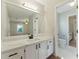 Bathroom featuring updated vanity with white cabinets, new hardware, and quartz countertops at 216 Tennis Court Nw Ln, Kennesaw, GA 30144