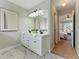 Bright bathroom featuring a double vanity with modern fixtures and marble floors at 216 Tennis Court Nw Ln, Kennesaw, GA 30144