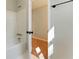Bright bathroom with white tiled floors, shower-tub combination, and updated fixtures at 216 Tennis Court Nw Ln, Kennesaw, GA 30144