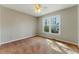 Sunny bedroom with a large window and neutral carpet at 216 Tennis Court Nw Ln, Kennesaw, GA 30144