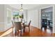 Bright dining room with hardwood floors, neutral walls, four chairs and a table, and a bay window at 216 Tennis Court Nw Ln, Kennesaw, GA 30144
