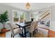 Charming dining room with hardwood floors, wainscoting, and views into the living area at 216 Tennis Court Nw Ln, Kennesaw, GA 30144