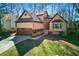 Charming home with a two-car garage, manicured lawn, and beautiful curb appeal at 216 Tennis Court Nw Ln, Kennesaw, GA 30144