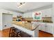 Bright kitchen features hardwood floors, white cabinetry, granite counters, a stainless steel oven and range at 216 Tennis Court Nw Ln, Kennesaw, GA 30144