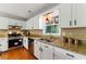 Bright kitchen features hardwood floors, white cabinetry, granite counters, and stainless steel appliances at 216 Tennis Court Nw Ln, Kennesaw, GA 30144