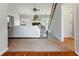 Open-concept living room with a fireplace, staircase, and natural light at 216 Tennis Court Nw Ln, Kennesaw, GA 30144