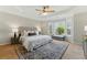 Relaxing bedroom features tray ceiling, large windows, and a cozy sitting area with an area rug at 216 Tennis Court Nw Ln, Kennesaw, GA 30144