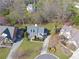 An aerial view of a single-Gathering home surrounded by other homes, a lawn, and trees at 4675 Allistair Dr, Cumming, GA 30040