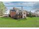 Large, green backyard with a view of the home's exterior, decks, and basketball hoop, perfect for outdoor fun at 4675 Allistair Dr, Cumming, GA 30040