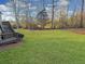 Large backyard with green grass leading to wooded area, creating a serene and private outdoor space at 4675 Allistair Dr, Cumming, GA 30040