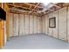 Unfinished basement area with exposed wood framing, insulation, and painted floor for potential customization at 4675 Allistair Dr, Cumming, GA 30040