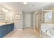 Bathroom featuring a tub, walk-in shower with tile surround, and granite countertop at 4675 Allistair Dr, Cumming, GA 30040