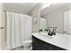 Bathroom with tiled floors, patterned shower curtain, and granite-topped vanity at 4675 Allistair Dr, Cumming, GA 30040