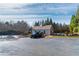 Well-maintained community clubhouse and tennis courts with parking and manicured landscaping on a partly cloudy day at 4675 Allistair Dr, Cumming, GA 30040