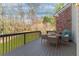 Deck area with seating, ideal for outdoor dining and enjoying views of the grassy backyard at 4675 Allistair Dr, Cumming, GA 30040