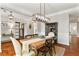 Elegant dining area with hardwood floors, stylish lighting, and neutral wall color at 4675 Allistair Dr, Cumming, GA 30040