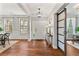 Bright and welcoming entryway with hardwood floors and a sliding barn door feature at 4675 Allistair Dr, Cumming, GA 30040
