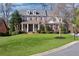 Beautiful two-story brick home featuring a manicured lawn and charming front porch with white columns at 4675 Allistair Dr, Cumming, GA 30040