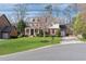Stately two-story brick home with a manicured lawn, basketball hoop, and inviting front porch at 4675 Allistair Dr, Cumming, GA 30040