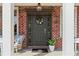 Inviting front entry with a charming floral wreath, stylish decor, and brick surround at 4675 Allistair Dr, Cumming, GA 30040