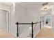 Upstairs hallway featuring a dark railing and neutral walls and floors at 4675 Allistair Dr, Cumming, GA 30040