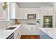 Well-appointed kitchen with white cabinetry, stone backsplash, stainless steel appliances, and hardwood floors at 4675 Allistair Dr, Cumming, GA 30040