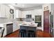Modern kitchen with white cabinets, granite countertops, stainless steel appliances, and a breakfast bar at 4675 Allistair Dr, Cumming, GA 30040