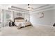 Spacious main bedroom featuring a tray ceiling, soft neutral colors, and carpeted floor at 4675 Allistair Dr, Cumming, GA 30040