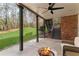 Covered patio with a fire pit and ceiling fan, creating a comfortable outdoor living space at 4675 Allistair Dr, Cumming, GA 30040