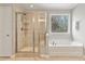 Bathroom featuring a glass door shower and soaking tub with tiled surround and window at 4675 Allistair Dr, Cumming, GA 30040