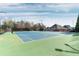 Community tennis court with nets, lighting, and fencing for recreational play at 4675 Allistair Dr, Cumming, GA 30040