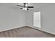 Bright bedroom features plush carpeting, a ceiling fan, and a window with white blinds at 6600 Commonwood Pl, Atlanta, GA 30349