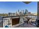 Balcony with city view, a table with two chairs, and railing decoration at 285 Centennial Olympic Park Nw Dr # 904, Atlanta, GA 30313
