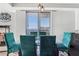 Bright dining area with glass table, velvet chairs and a view at 285 Centennial Olympic Park Nw Dr # 904, Atlanta, GA 30313
