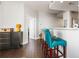 Hallway to kitchen featuring breakfast bar, stainless steel appliances, dark hardwood floors, and neutral color scheme at 285 Centennial Olympic Park Nw Dr # 904, Atlanta, GA 30313