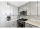 Efficient kitchen design with stainless steel appliances, stone countertops, and gray cabinetry for a modern appeal at 285 Centennial Olympic Park Nw Dr # 904, Atlanta, GA 30313
