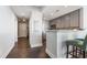 Hallway to kitchen featuring breakfast bar, stainless steel appliances, dark hardwood floors, and neutral color scheme at 285 Centennial Olympic Park Nw Dr # 904, Atlanta, GA 30313