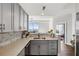 Contemporary kitchen boasts gray cabinets, stone countertops, stainless steel sink and finishes, with a view at 285 Centennial Olympic Park Nw Dr # 904, Atlanta, GA 30313