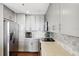 Modern kitchen with stainless steel appliances, gray cabinets and countertops and tile backsplash for a luxurious feel at 285 Centennial Olympic Park Nw Dr # 904, Atlanta, GA 30313