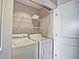 Efficient laundry room with white washer and dryer and wire shelving for storage at 285 Centennial Olympic Park Nw Dr # 904, Atlanta, GA 30313