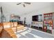 Bright living room with modern ceiling fan, leather sofa, and built-in shelving, filled with natural light at 285 Centennial Olympic Park Nw Dr # 904, Atlanta, GA 30313