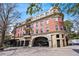 Elegant multi-story brick building featuring arched entryway, balconies, and manicured landscaping at 560 Dutch Valley Ne Rd # 2207, Atlanta, GA 30324