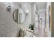 Elegant hallway with decorative wallpaper, ornate mirror, sconces, and long view to living space at 560 Dutch Valley Ne Rd # 2207, Atlanta, GA 30324
