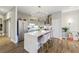 Open kitchen with large island, pendant lighting, stainless steel refrigerator, and sleek cabinetry at 560 Dutch Valley Ne Rd # 2207, Atlanta, GA 30324