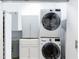 Well-organized laundry room with stacked washer/dryer and built-in storage cabinets at 560 Dutch Valley Ne Rd # 2207, Atlanta, GA 30324