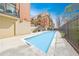 Outdoor pool area framed by brick buildings and blue skies offering a refreshing escape and community space at 560 Dutch Valley Ne Rd # 2207, Atlanta, GA 30324