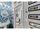 Stylish powder room with patterned wallpaper, pedestal sink and framed artwork at 560 Dutch Valley Ne Rd # 2207, Atlanta, GA 30324