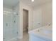 This bright bathroom features a large shower with white subway tile and a vanity with a sink at 179 Bluffington Way, Marietta, GA 30066